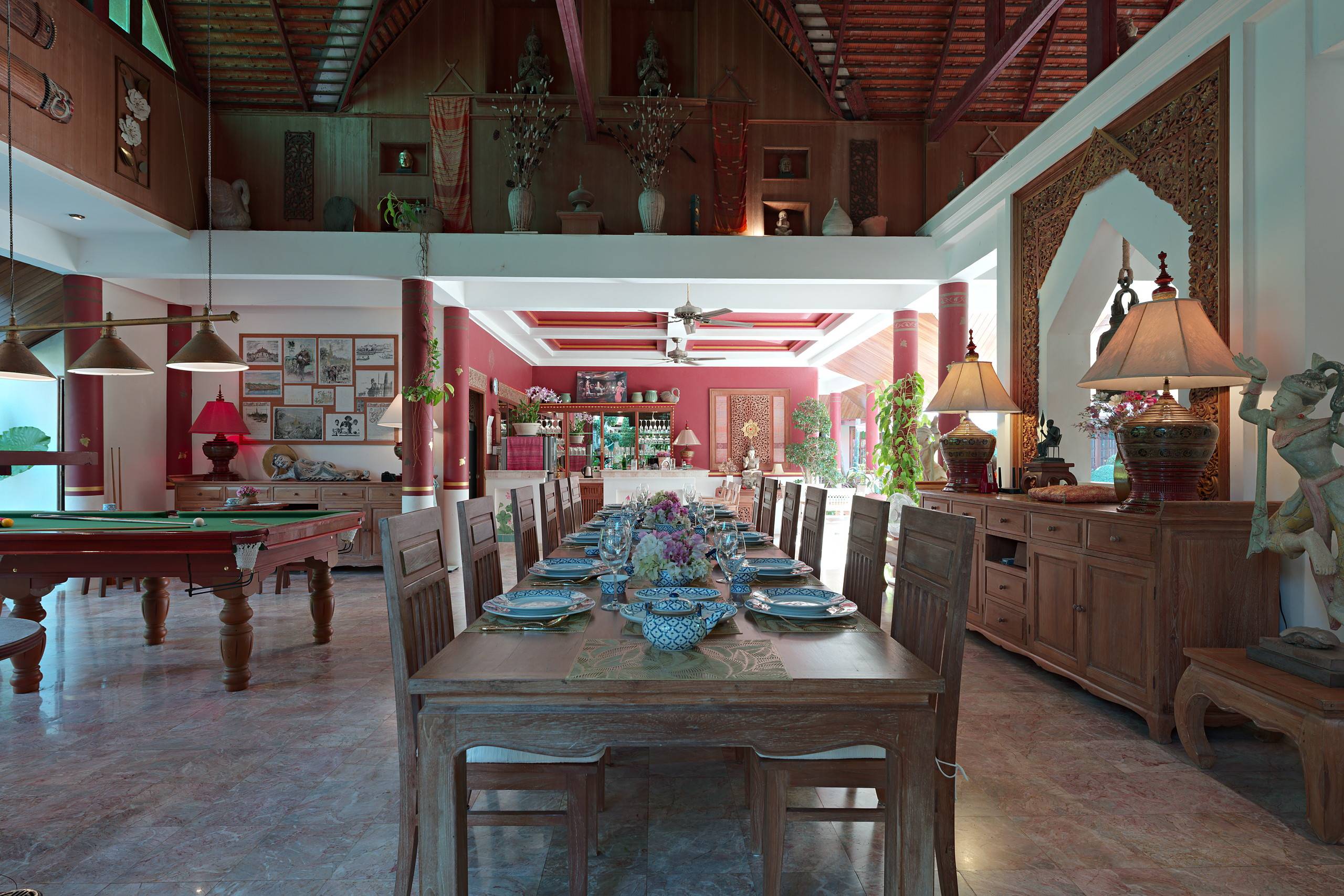 Dining table set for a dinner, pavilion open to the garden