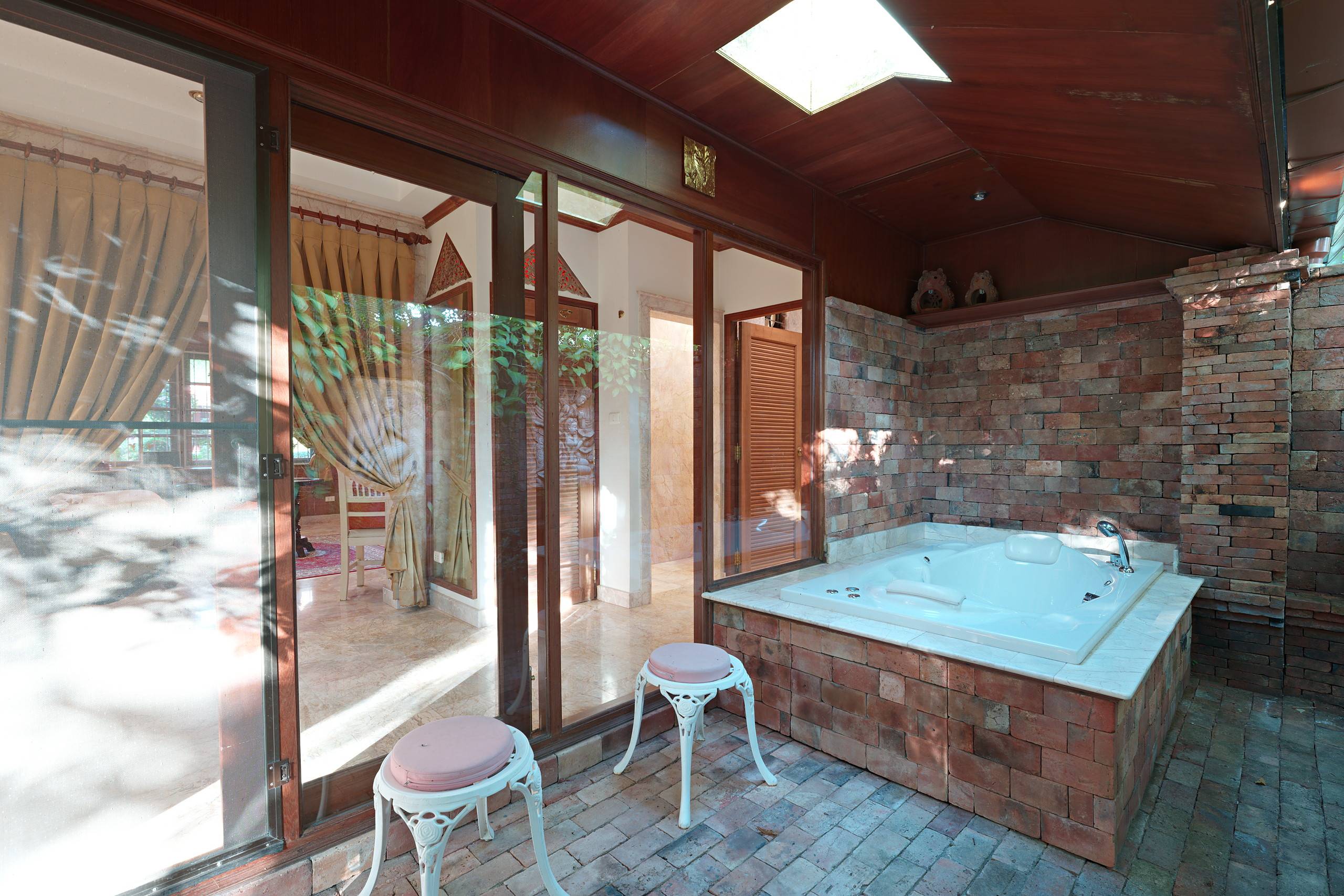 The master suite’s bath for two in its private brick courtyard
